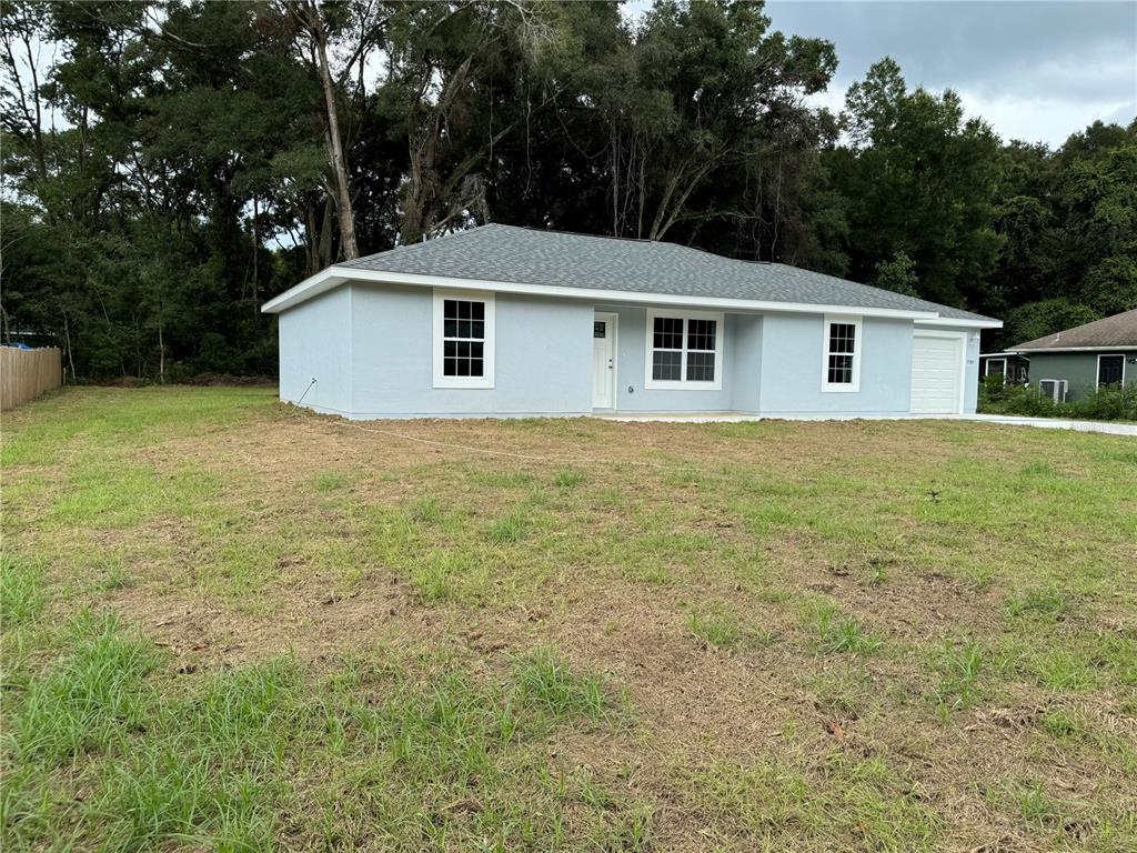 a front view of house with yard and trees