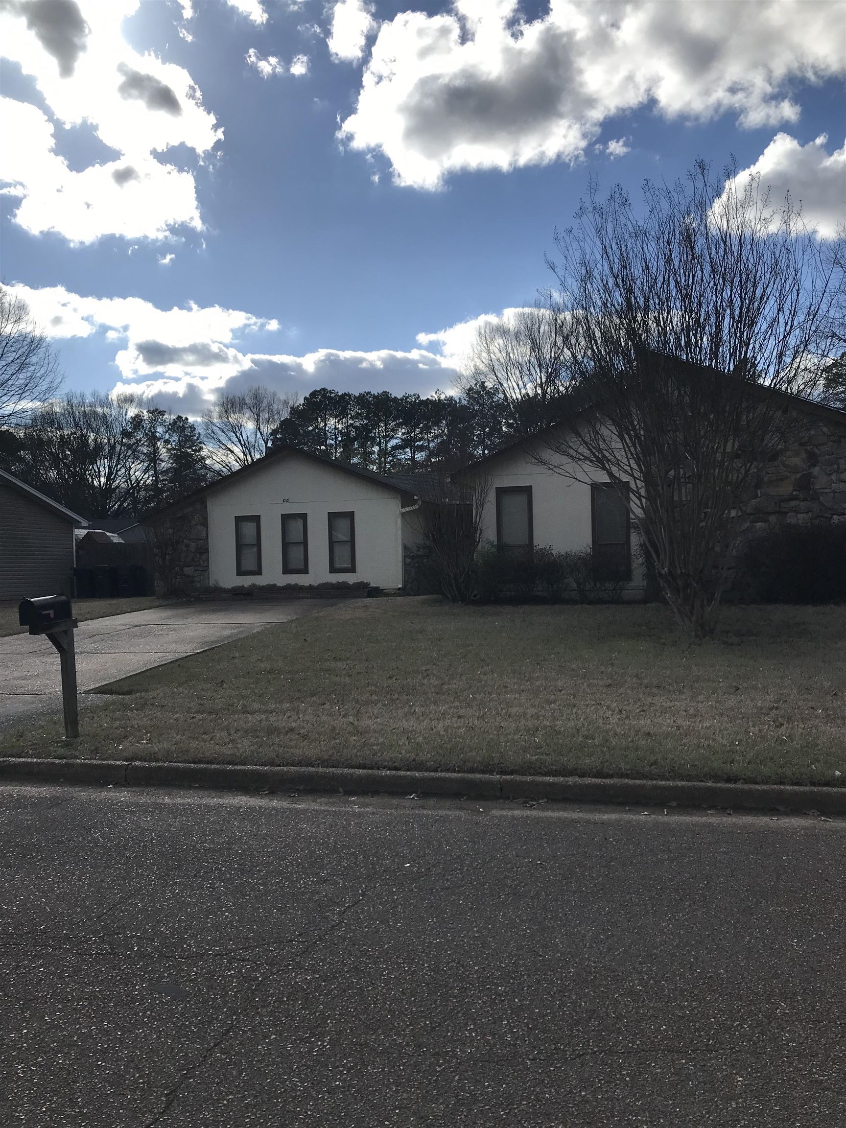 a view of house with a yard