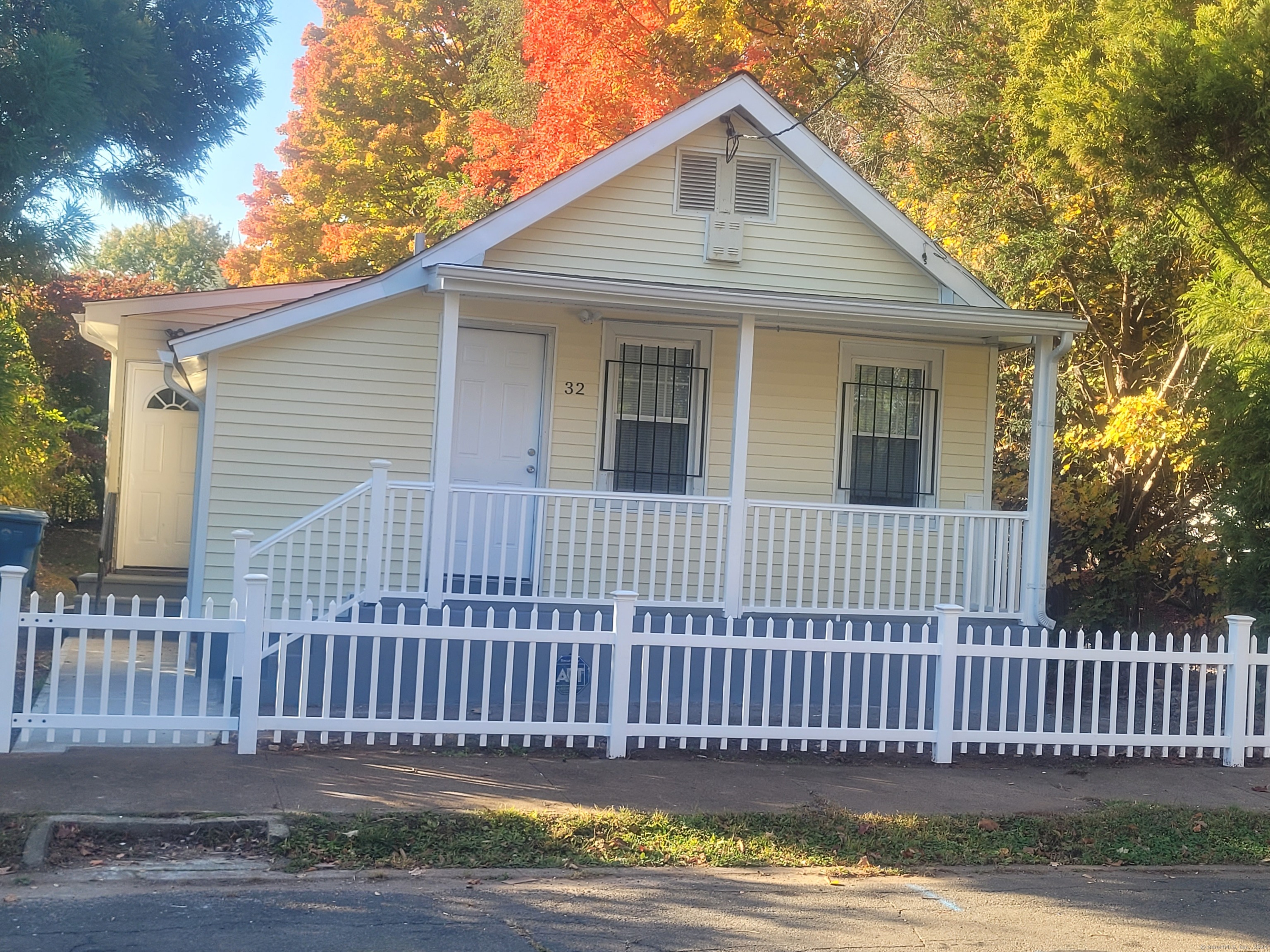 a view of a house with a wooden fence