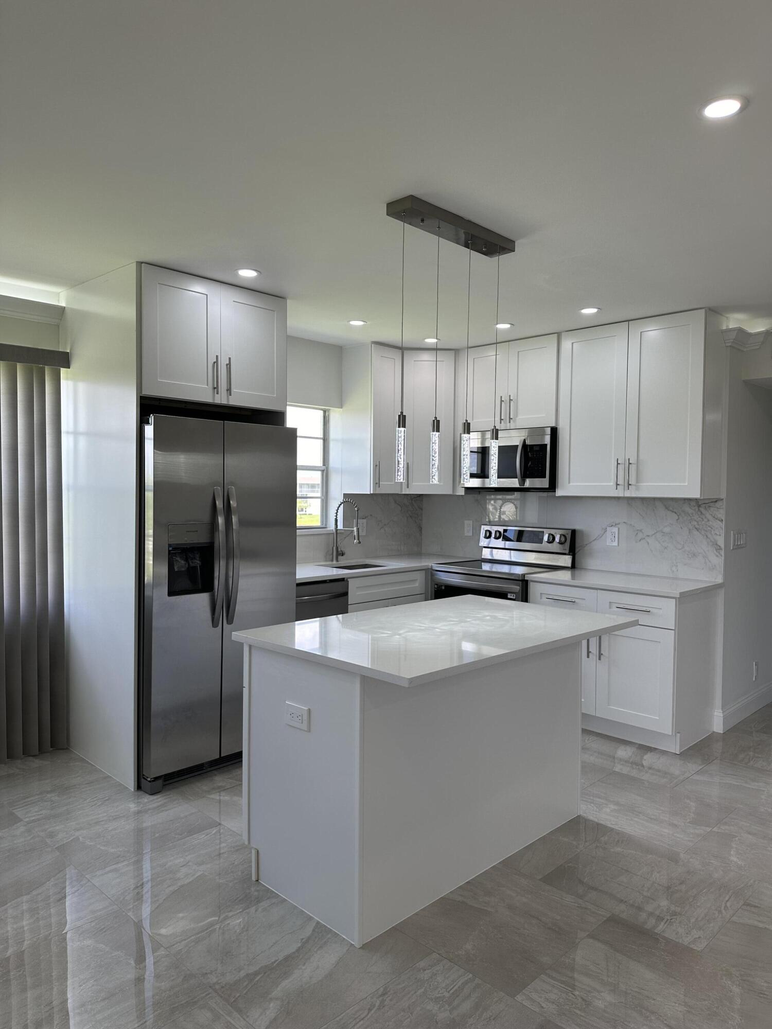 a kitchen with stainless steel appliances granite countertop a refrigerator sink and cabinets