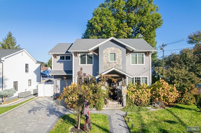 a front view of a house with yard and green space