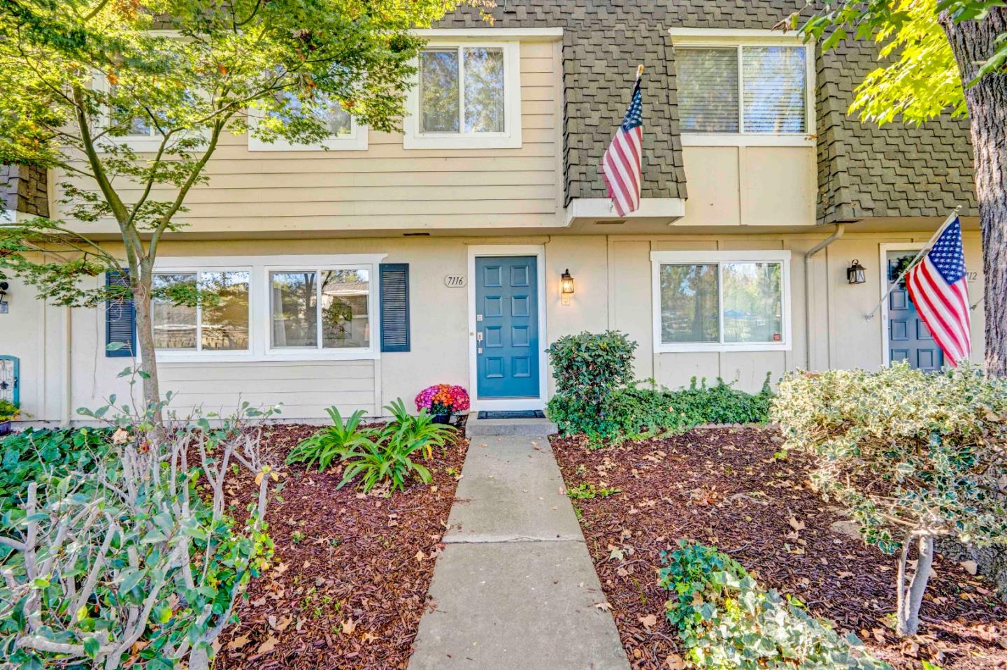 a front view of a house with garden