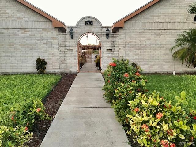 a pathway of a house with a yard