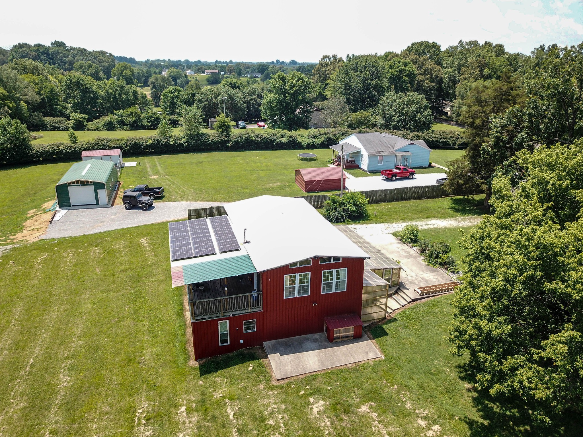 an aerial view of a house with swimming pool a yard and a large pool