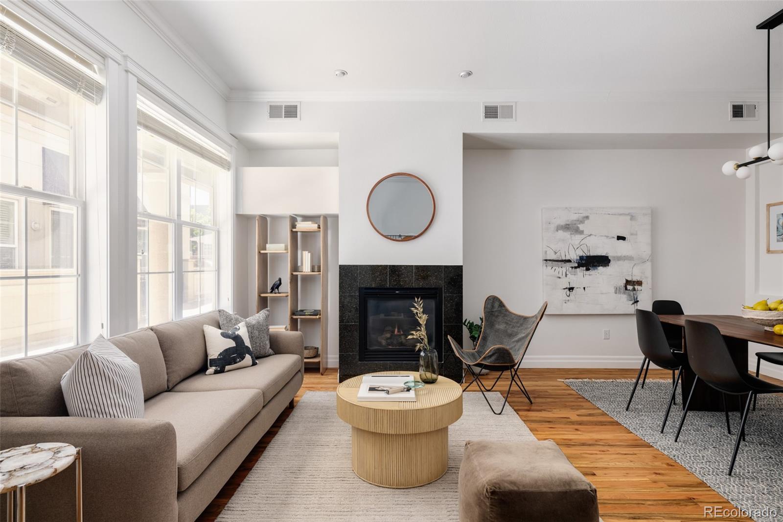 a living room with furniture and a fireplace