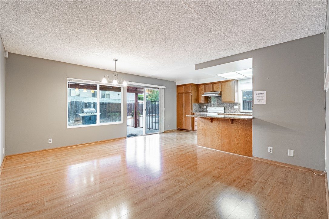 a view of kitchen with wooden floor and a window