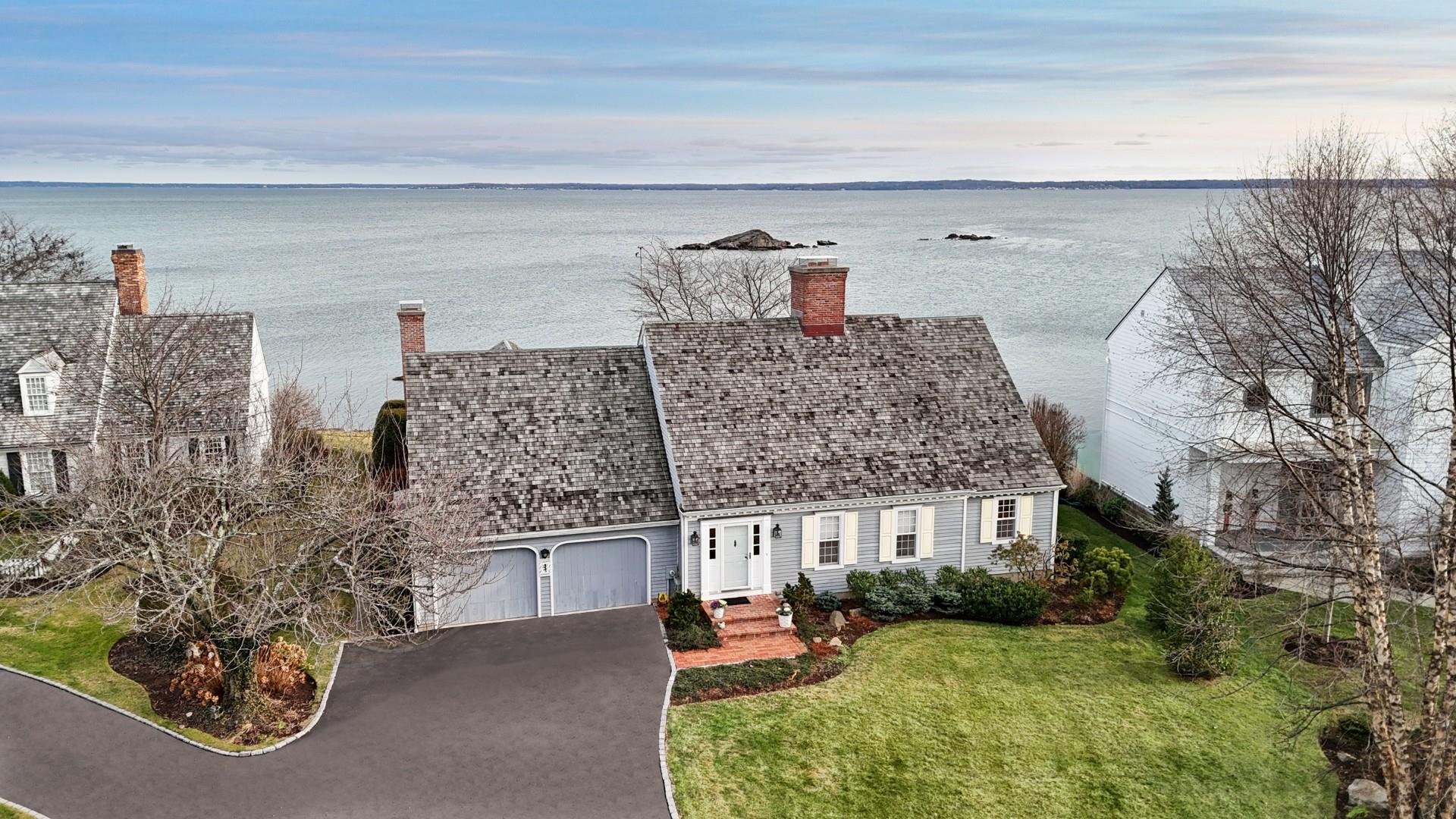 Birds eye view of property with a water view