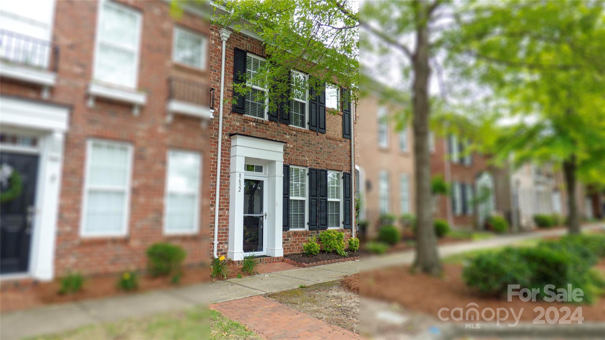 a view of a brick building next to a yard