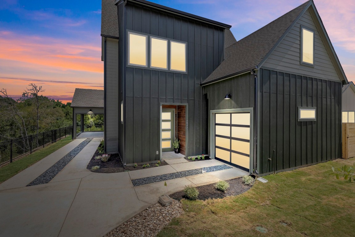 a view of a house with porch and wooden fence