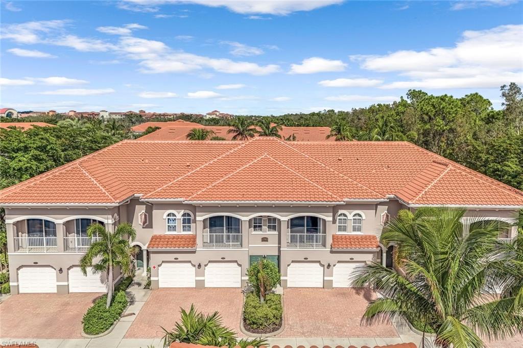 Mediterranean / spanish-style house with a garage and a balcony