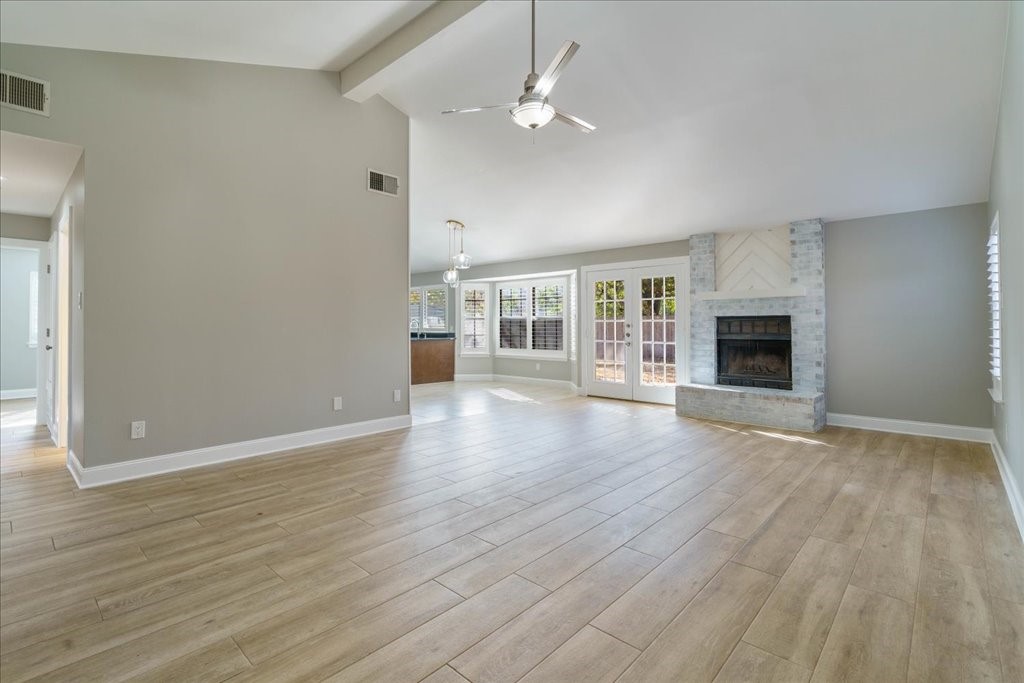 wooden floor in an empty room with a fireplace