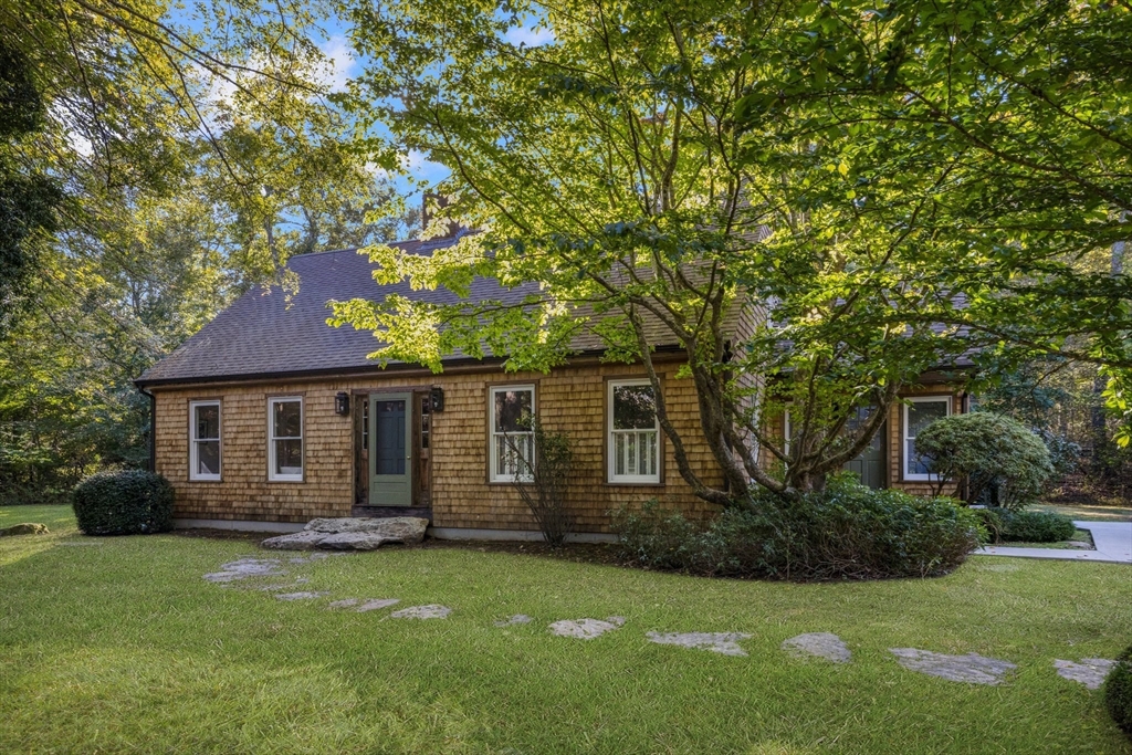 a front view of a house with a garden