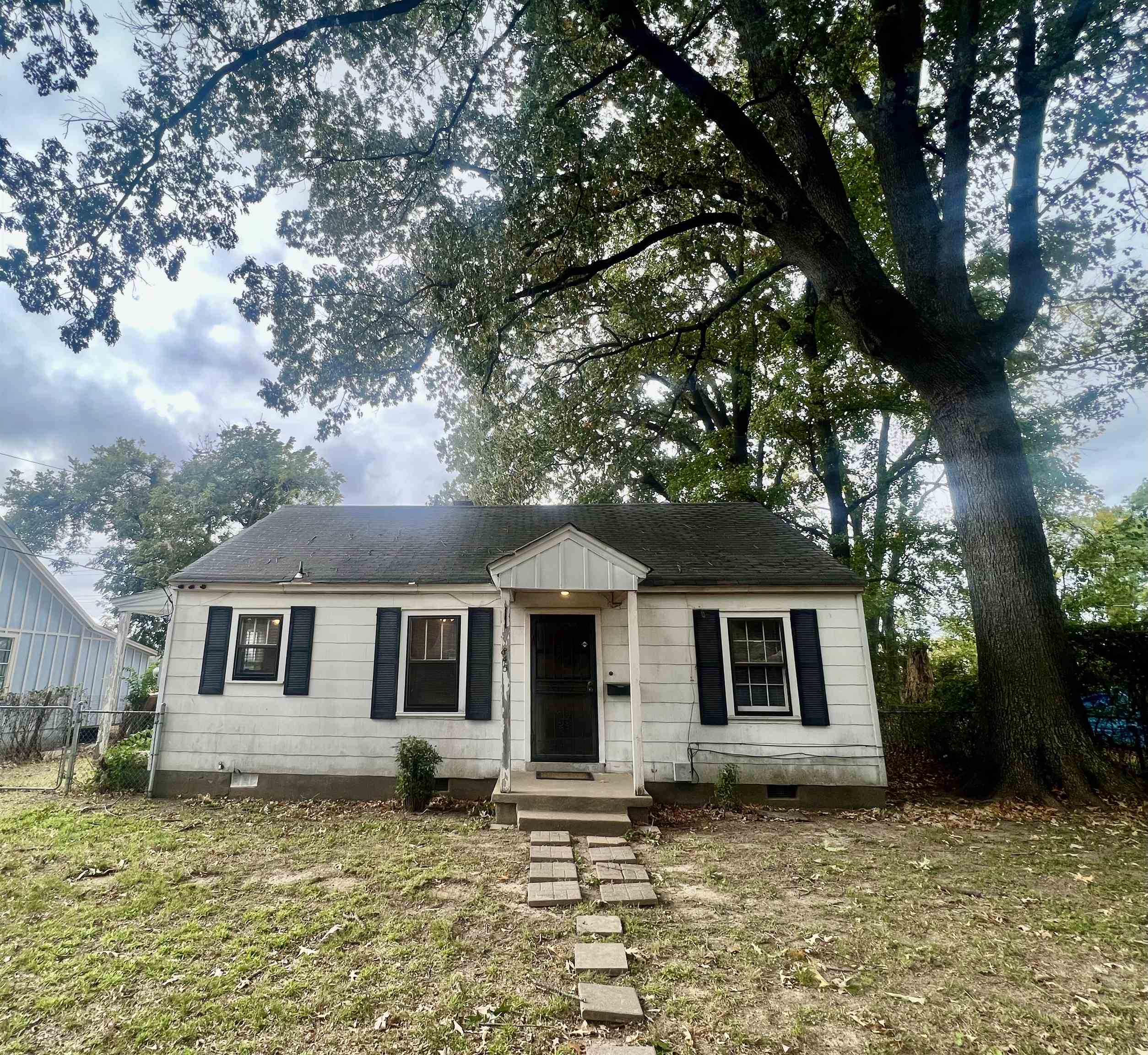 a front view of a house with a garden