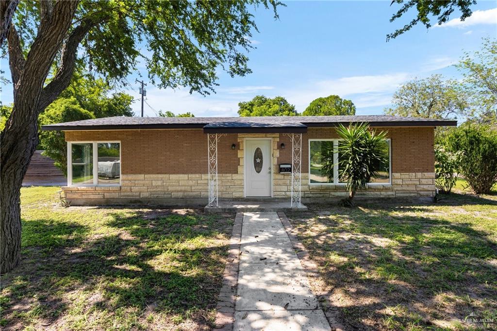 Ranch-style home with a front lawn