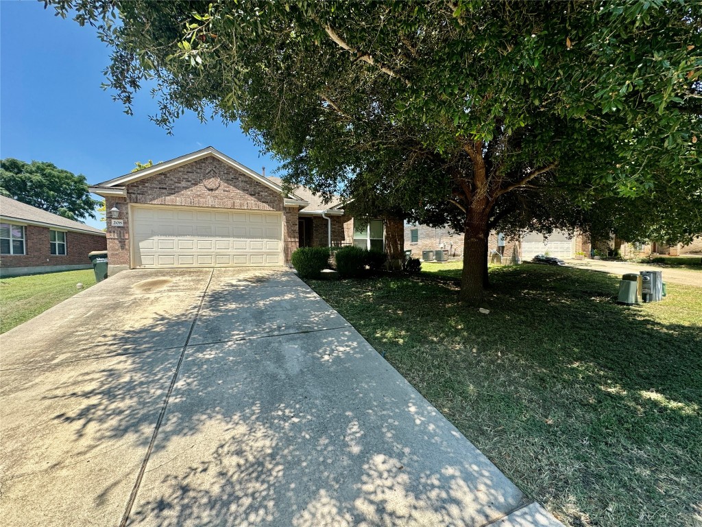 a front view of a house with a yard garage and outdoor seating