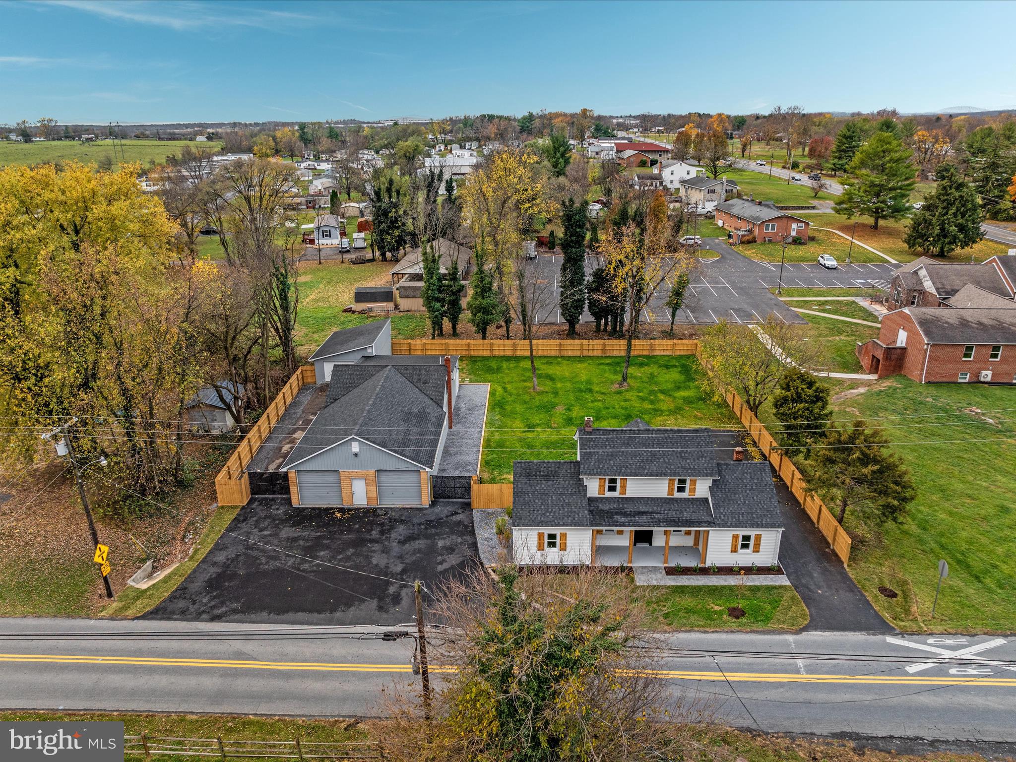 an aerial view of residential houses with outdoor space and swimming pool