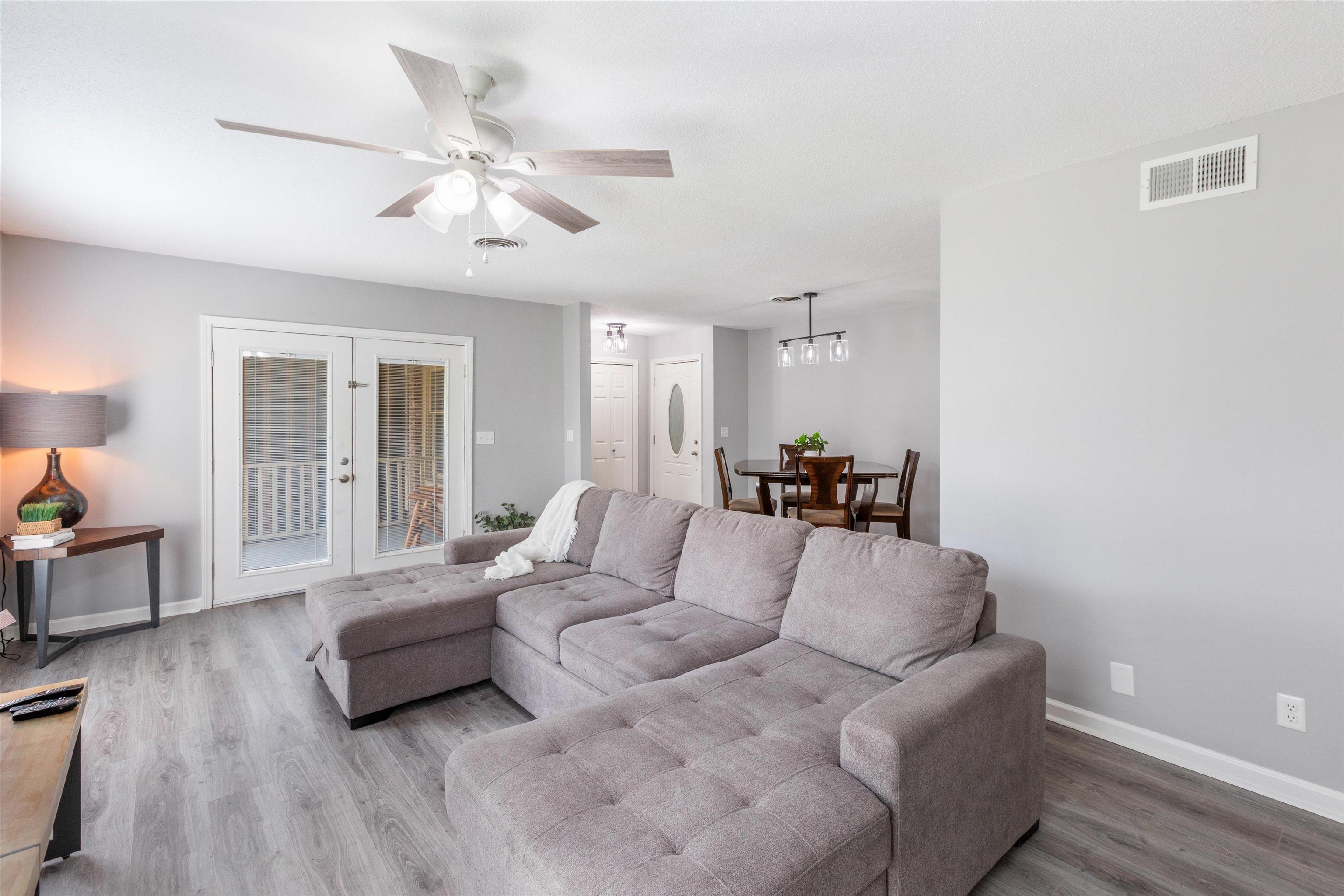 a living room with furniture and wooden floor