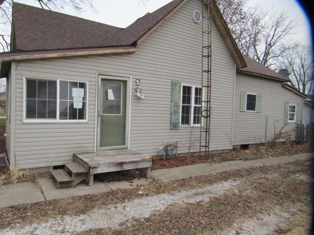 a view of a house with a yard and sitting area