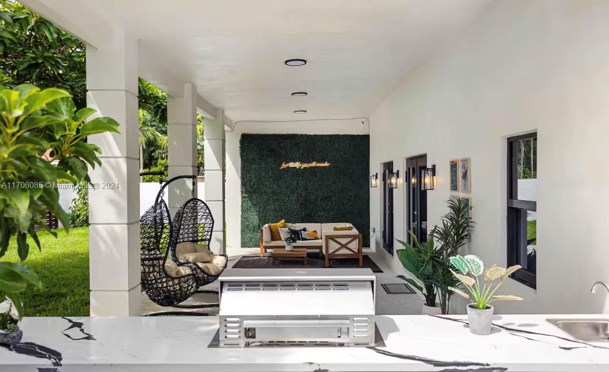 a living room with furniture and a potted plant