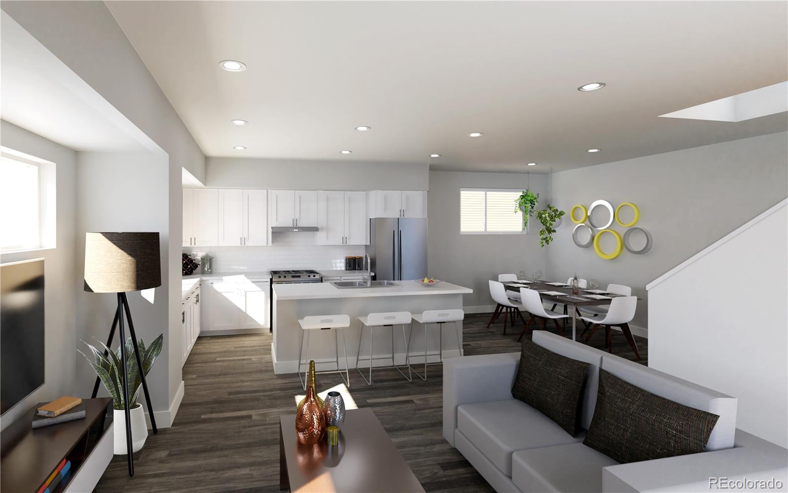 a living room with furniture a wooden floor and a kitchen view