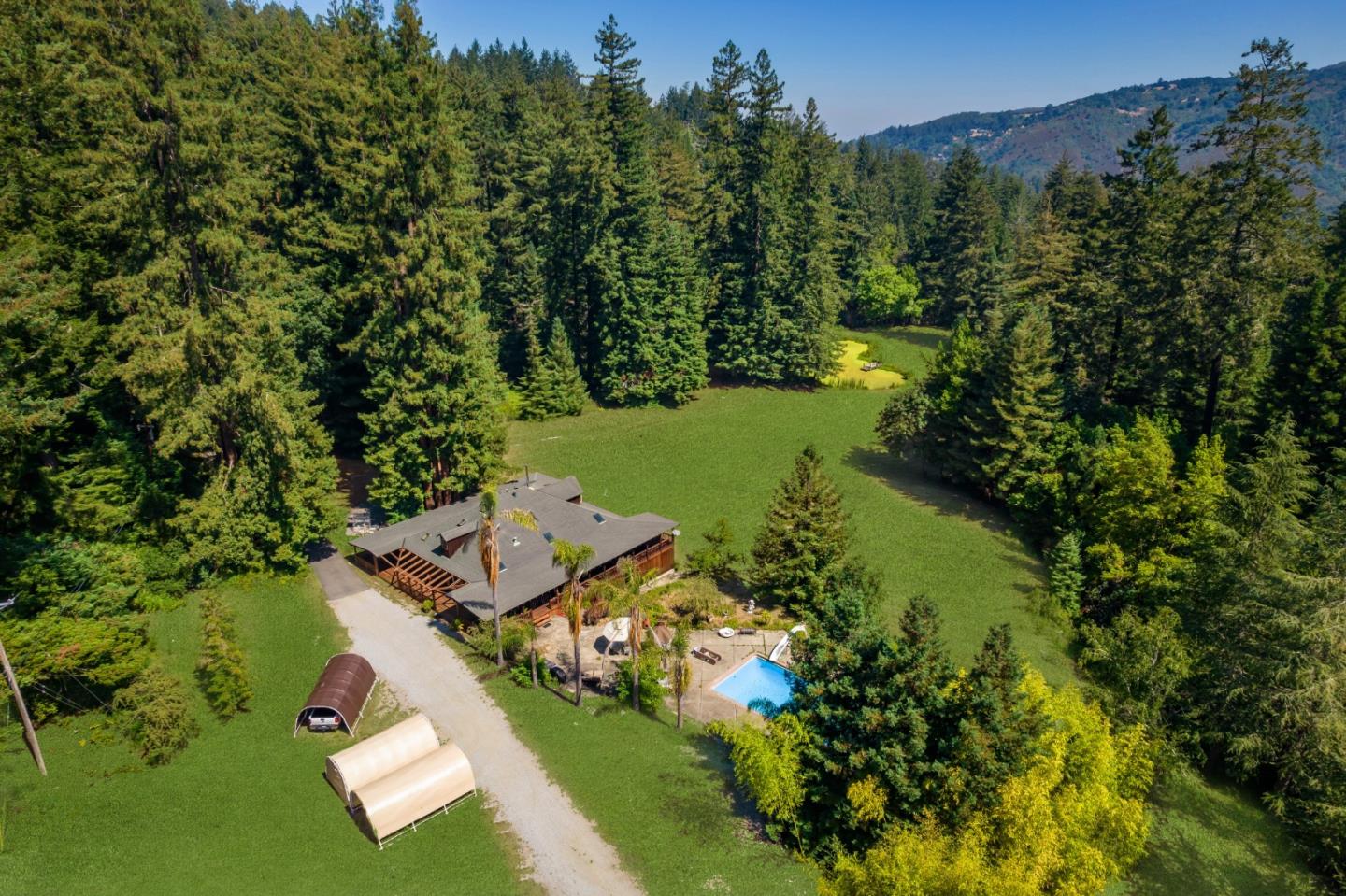 an aerial view of a house with a yard