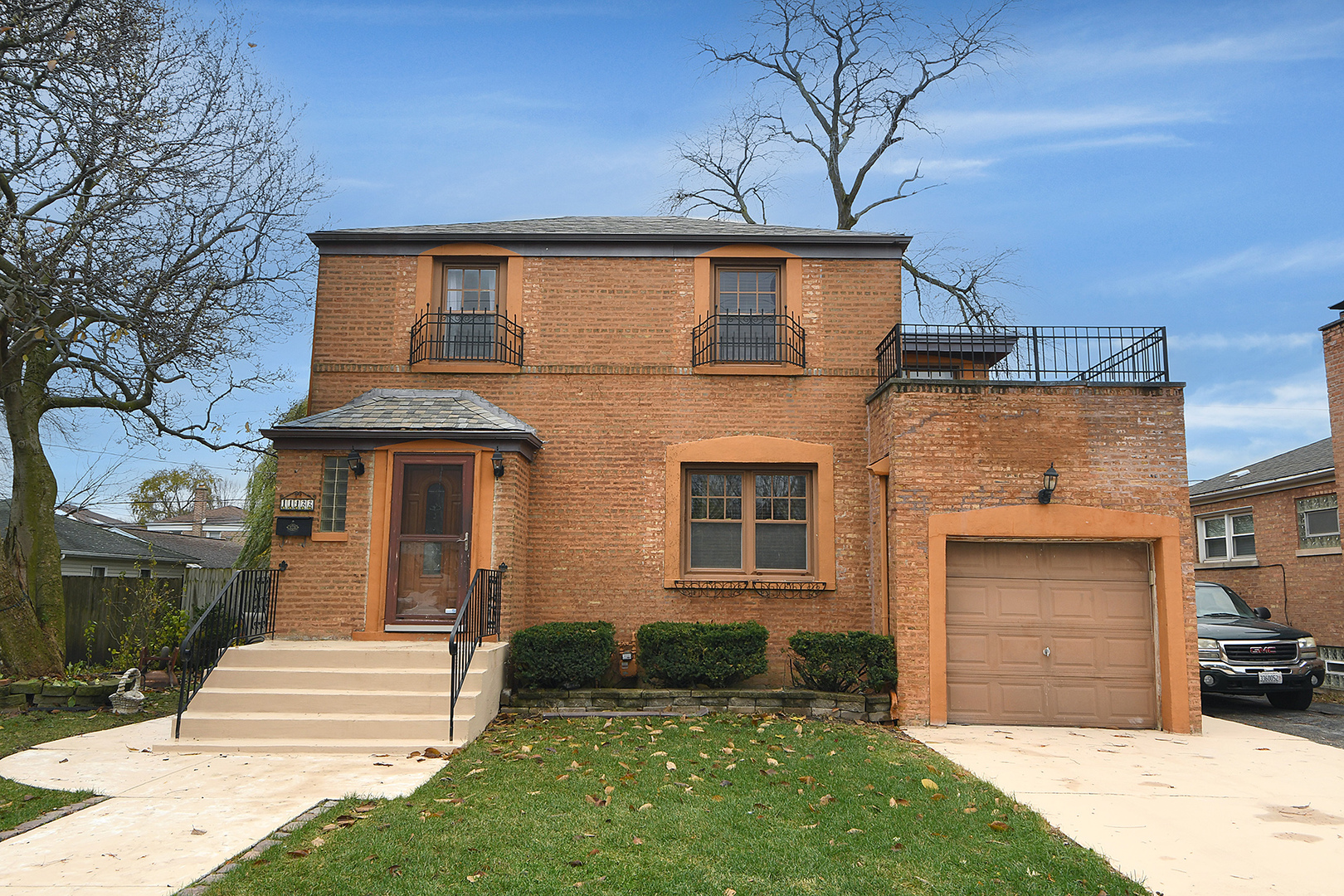 a front view of a house with a yard and garage