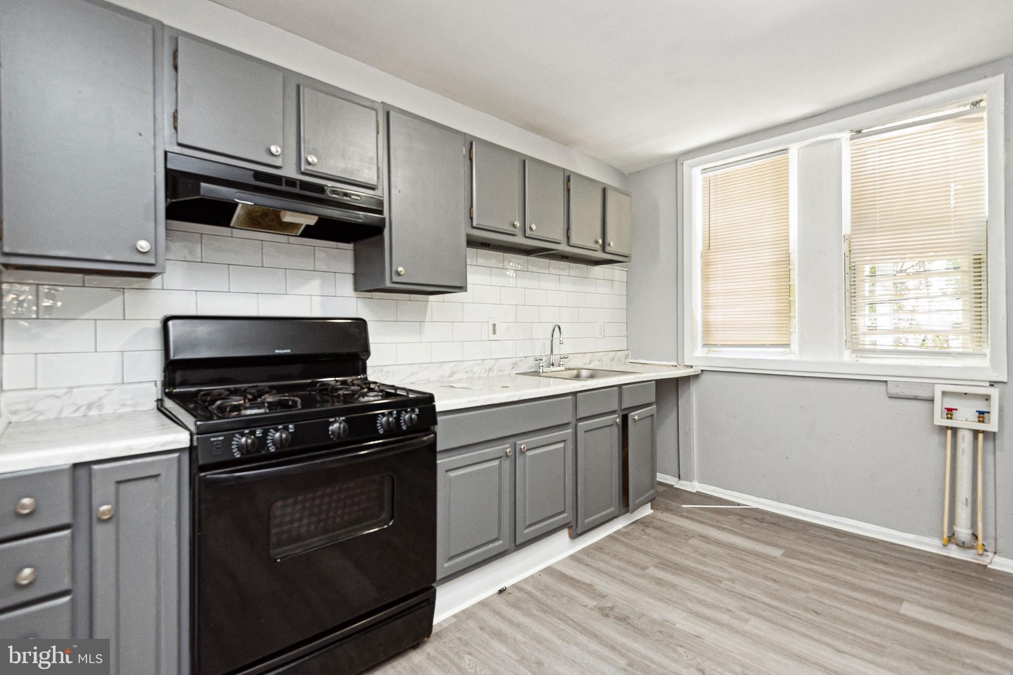 a kitchen with cabinets appliances and a window