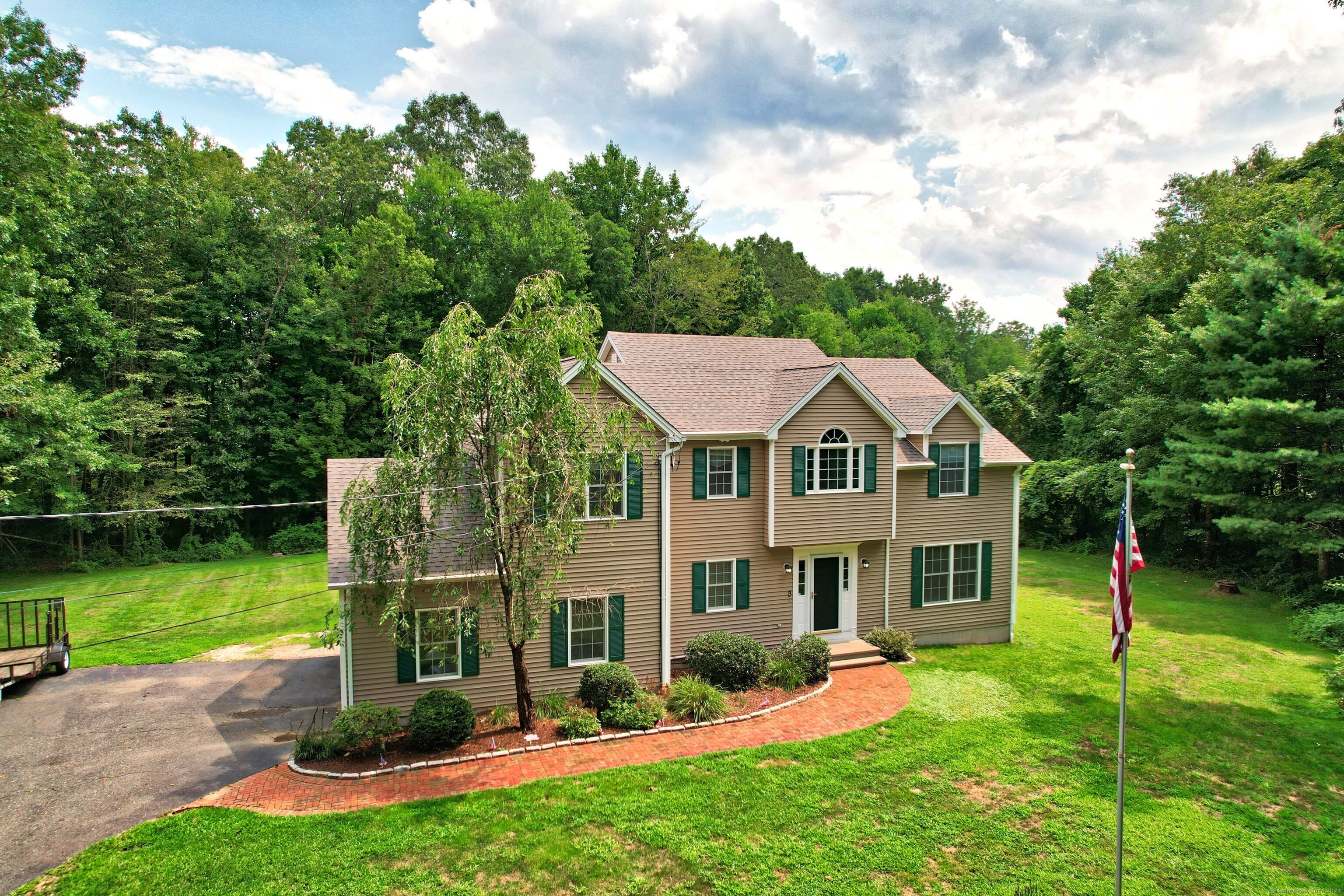 a aerial view of a house with swimming pool next to a big yard