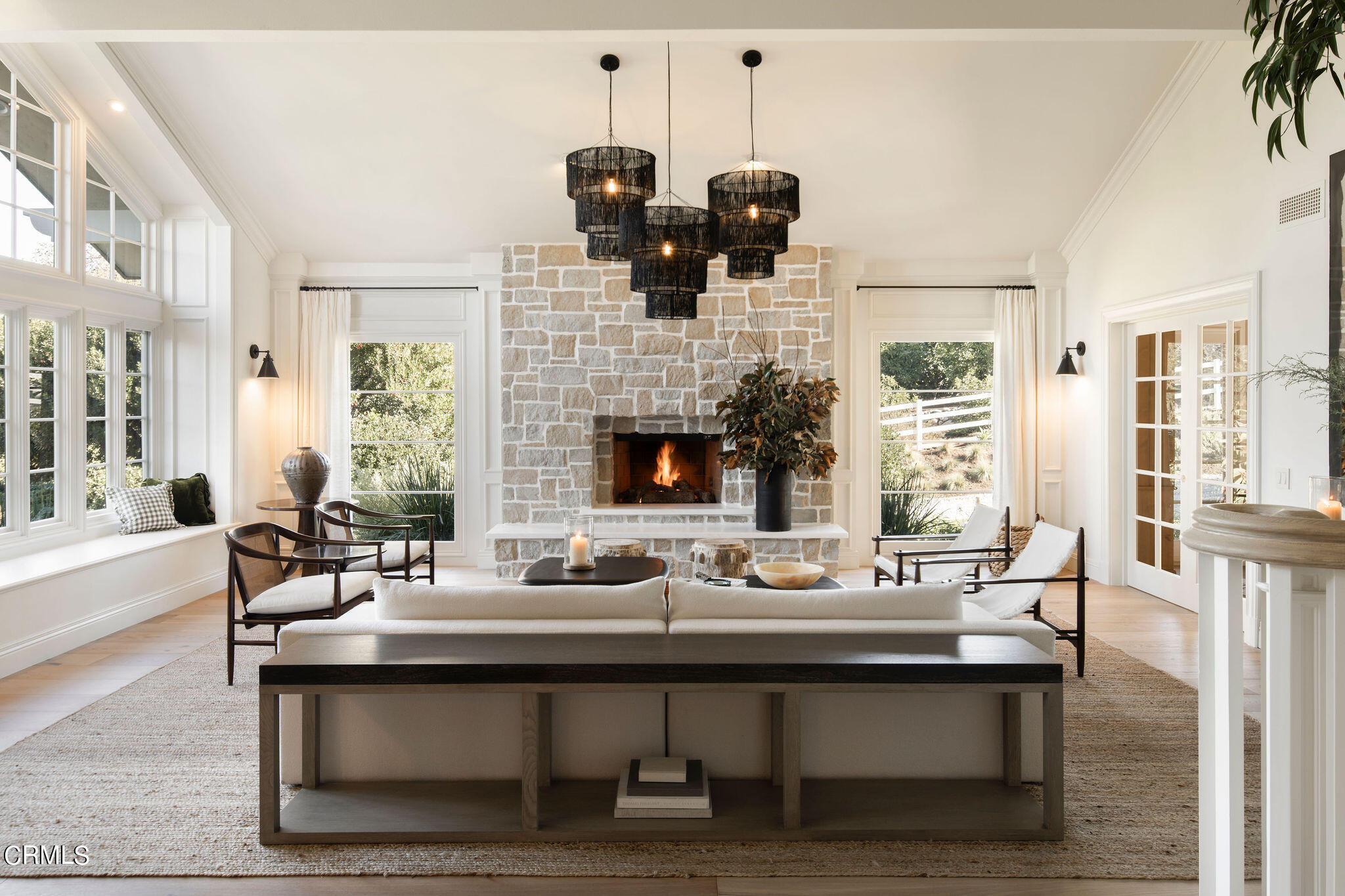 a living room with fireplace furniture and a large window