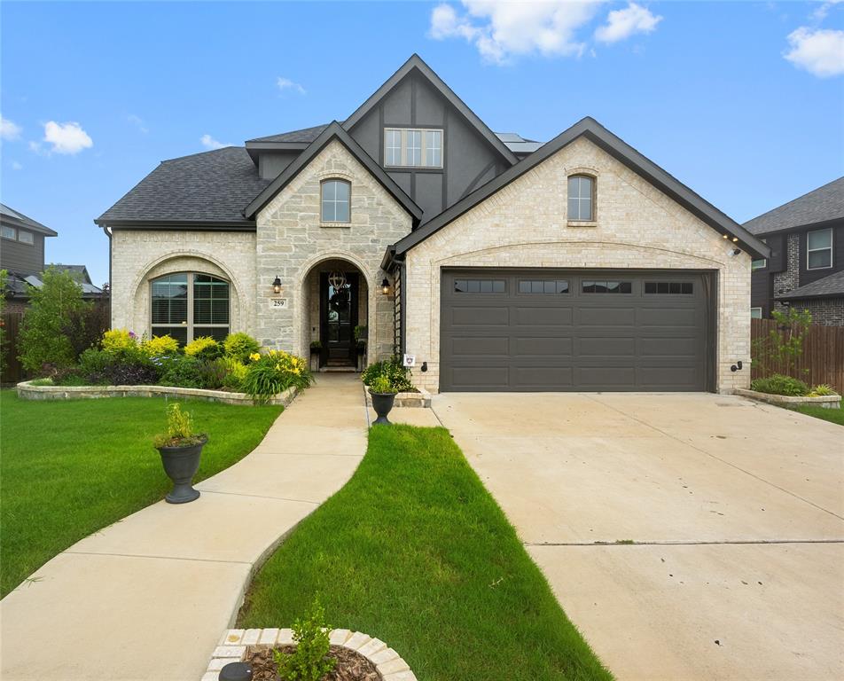 a front view of a house with a yard and garage