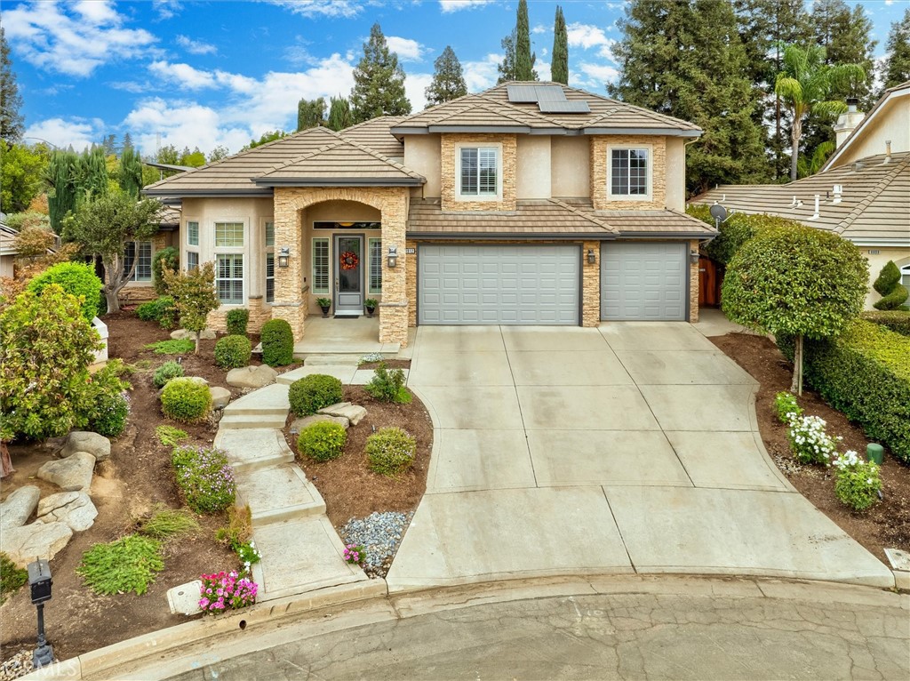 a front view of a house with garden