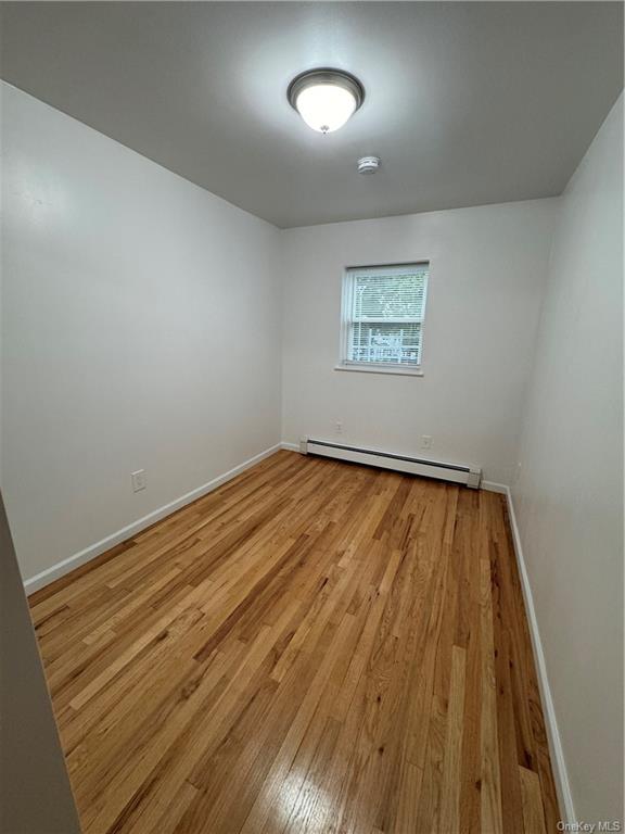 an empty room with wooden floor