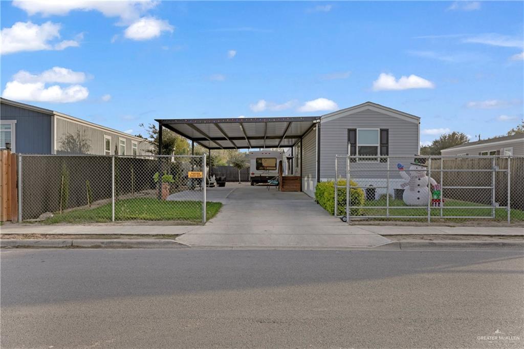 View of front of property with a carport