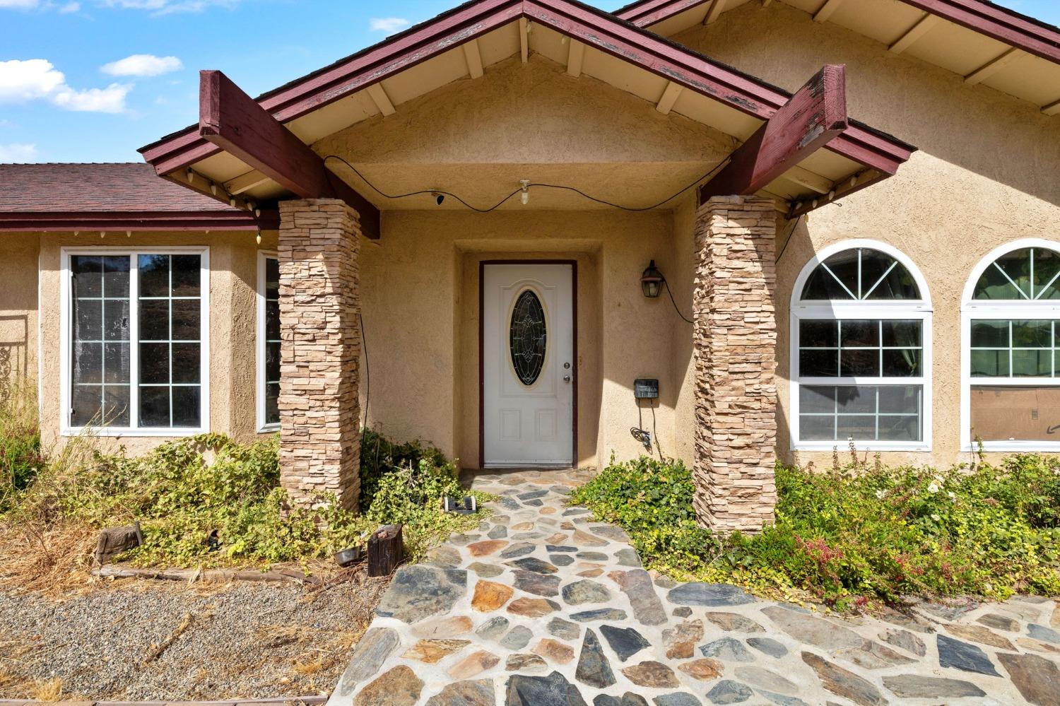 a front view of a house with garden