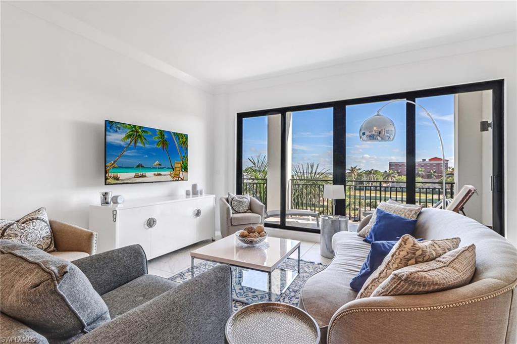 a living room with furniture large window and a flat screen tv