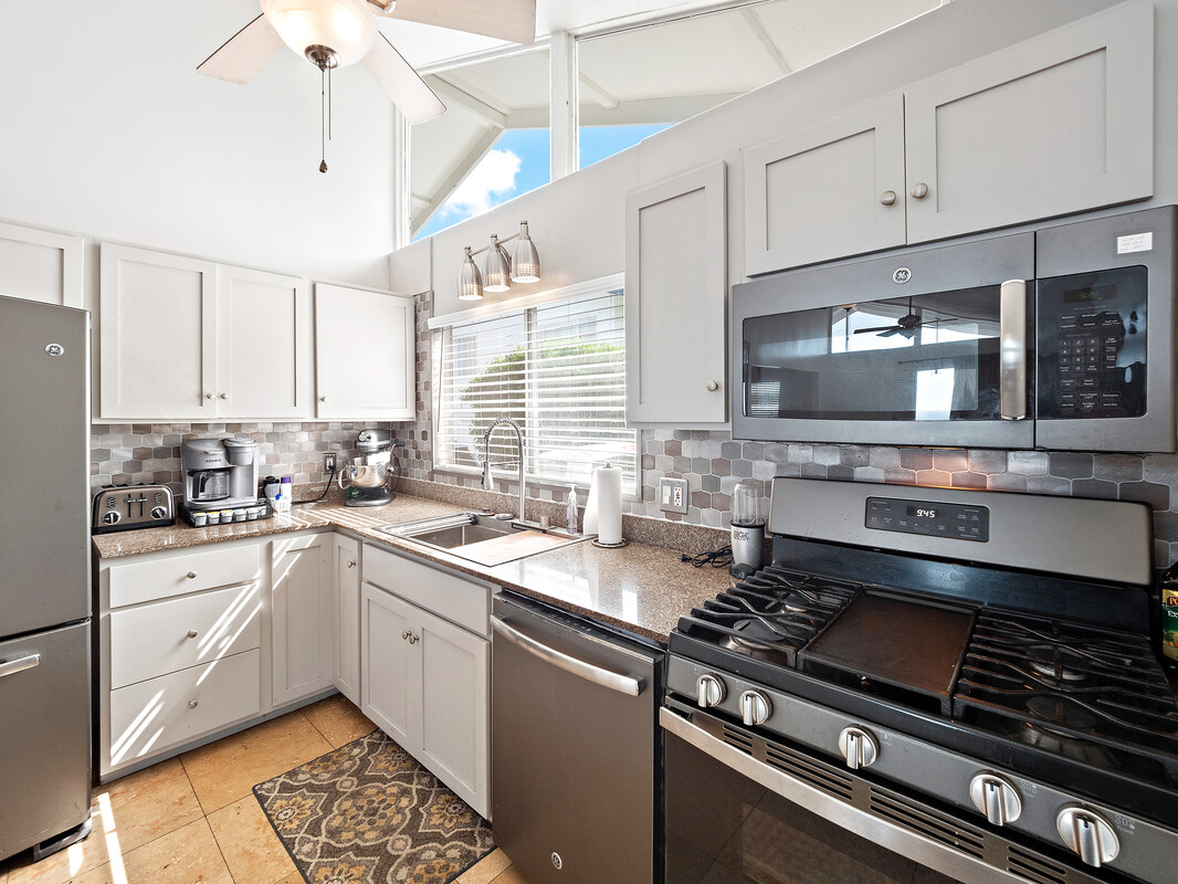 a kitchen with a sink stove top oven and cabinets