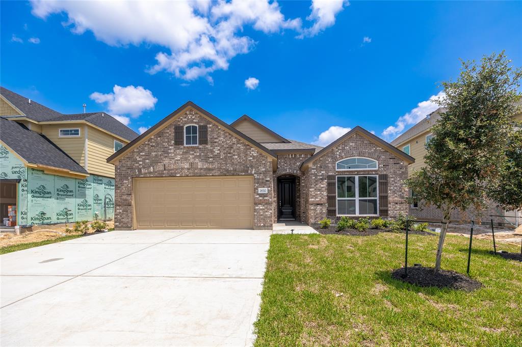 a front view of a house with a yard garage and outdoor seating