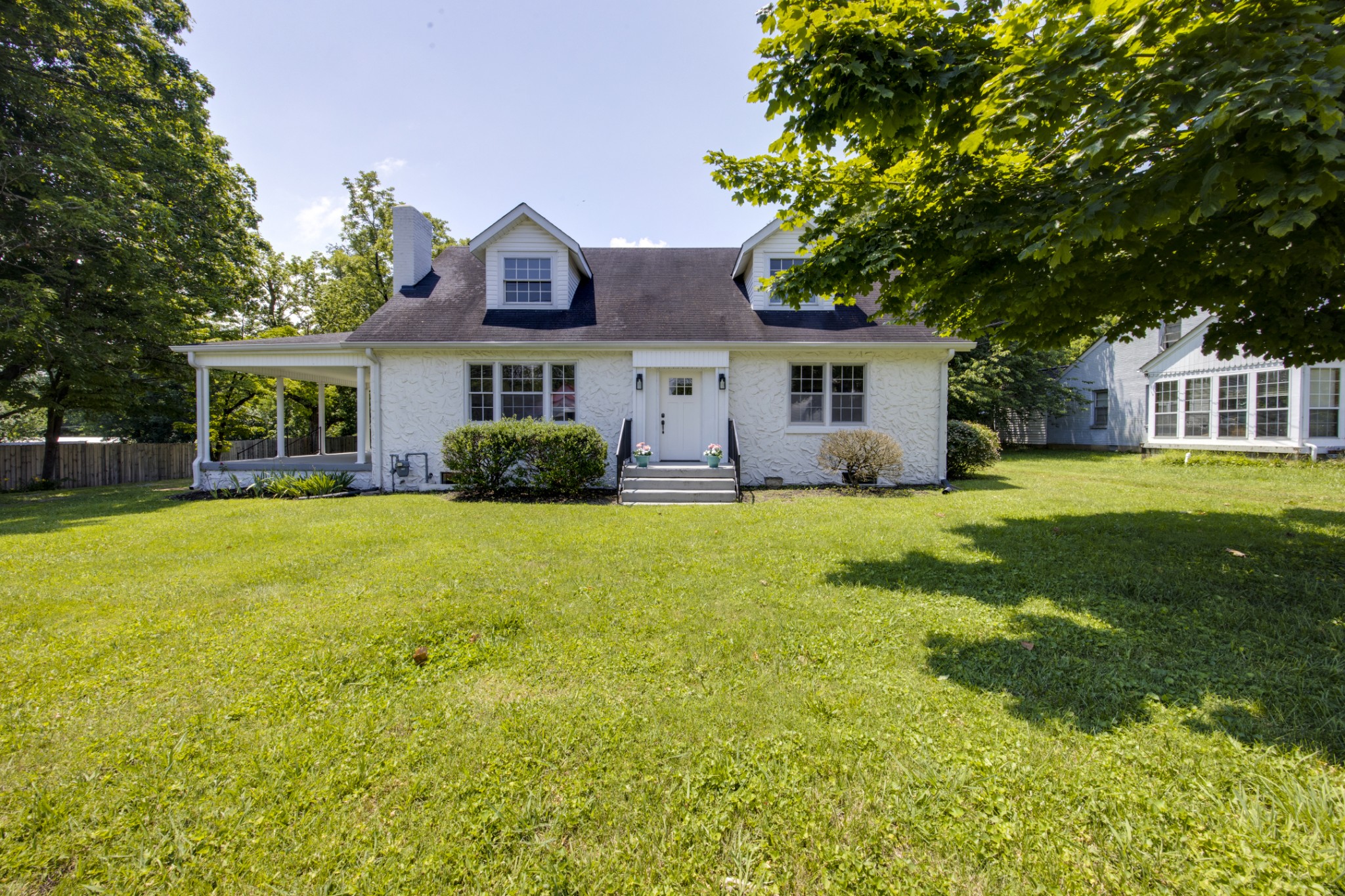 a front view of house with yard and green space