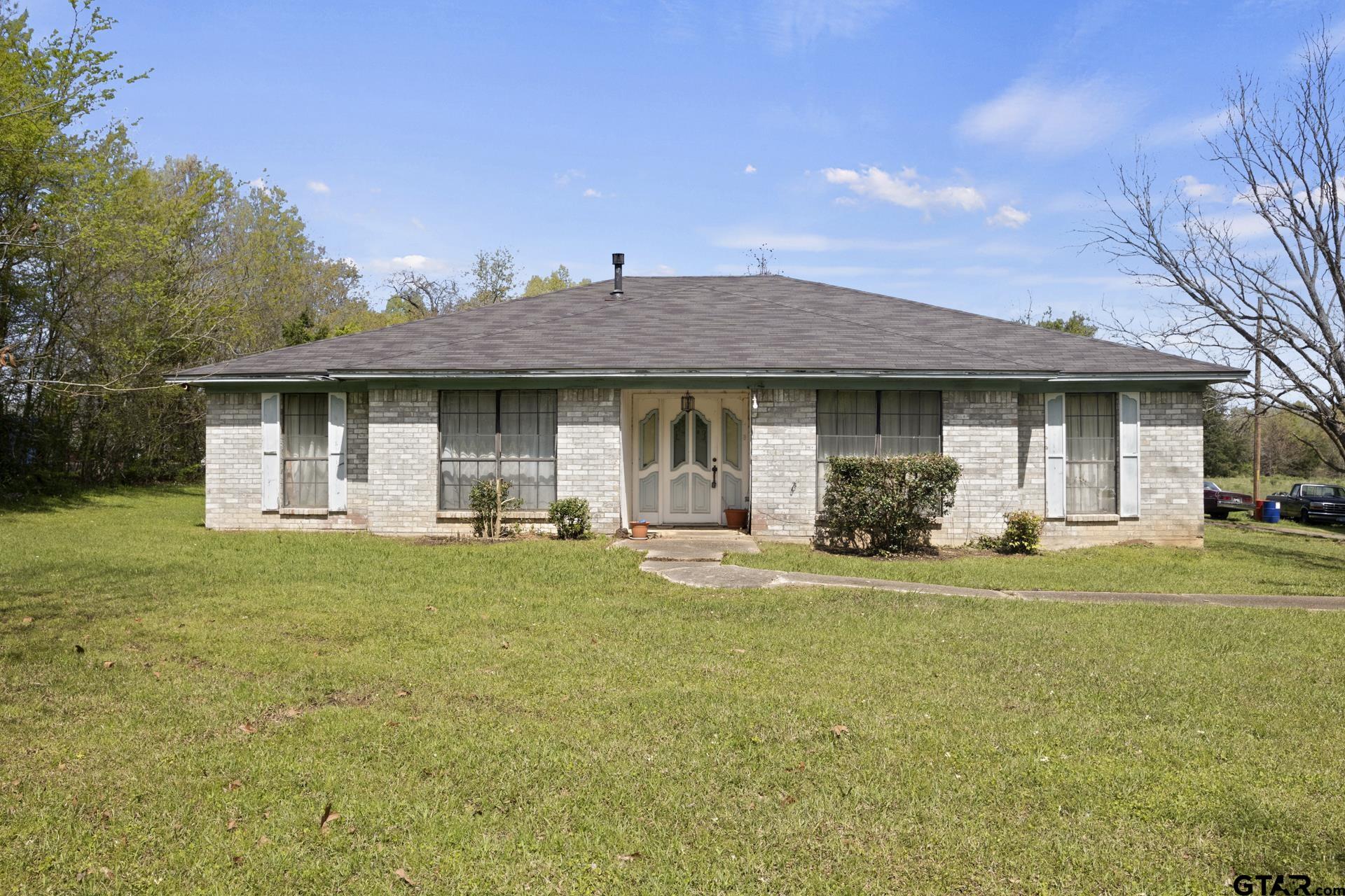 a front view of a house with a garden and porch