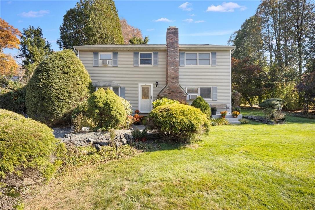 Back of house featuring a yard