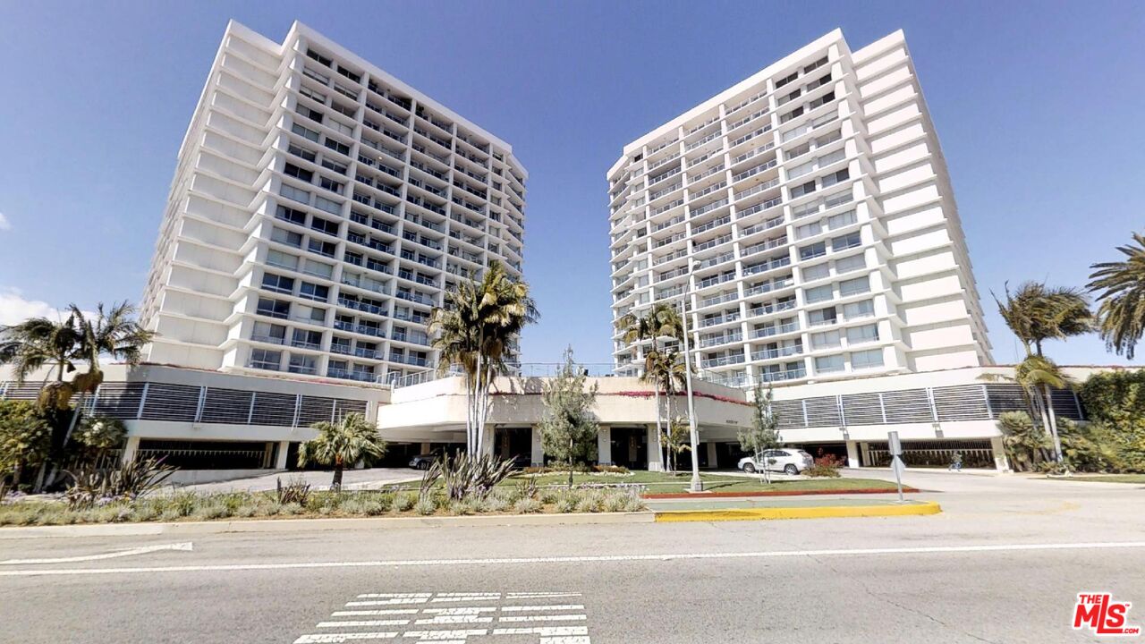 a view of a tall building next to a yard