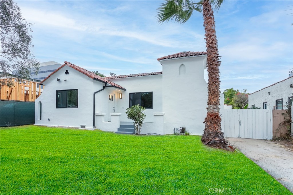 a front view of house with yard and outdoor seating