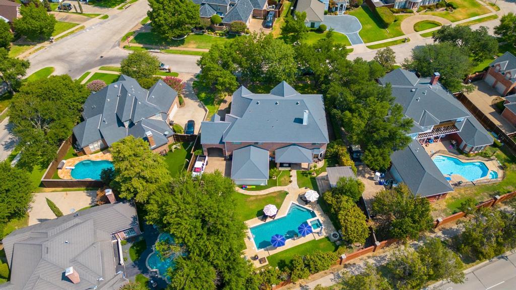 an aerial view of a house with a yard and outdoor seating