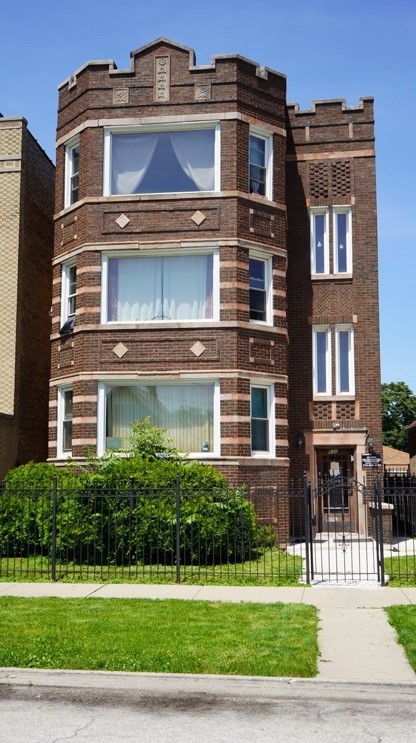 a front view of a residential apartment building with a yard