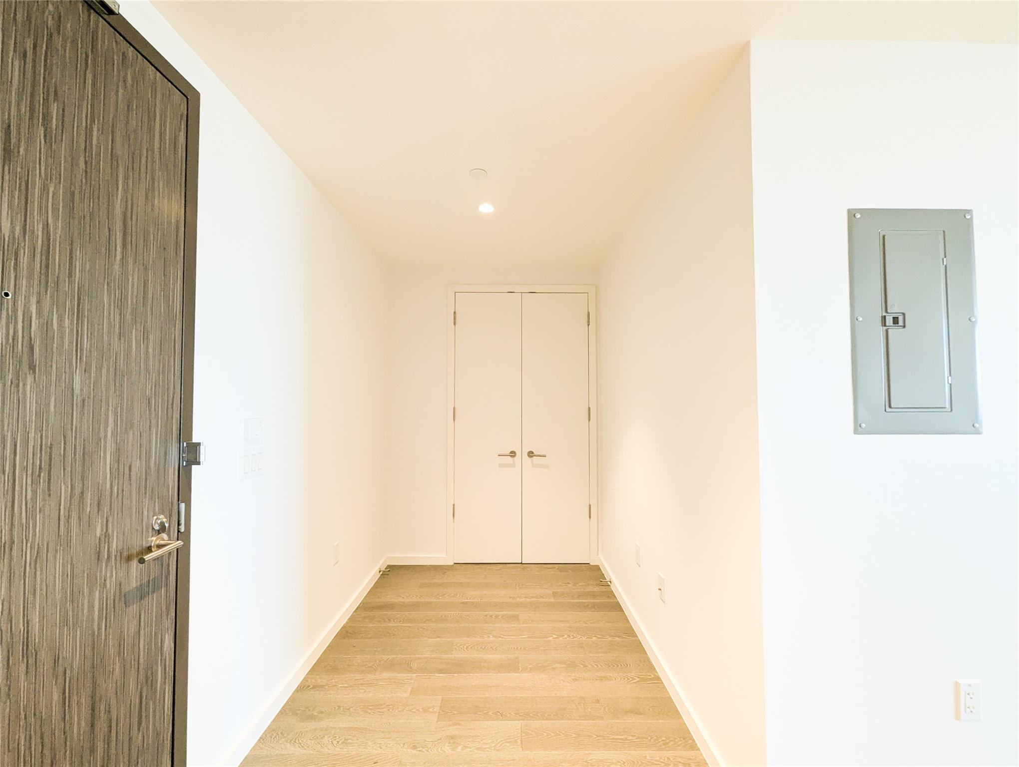 a view of a hallway with wooden floor