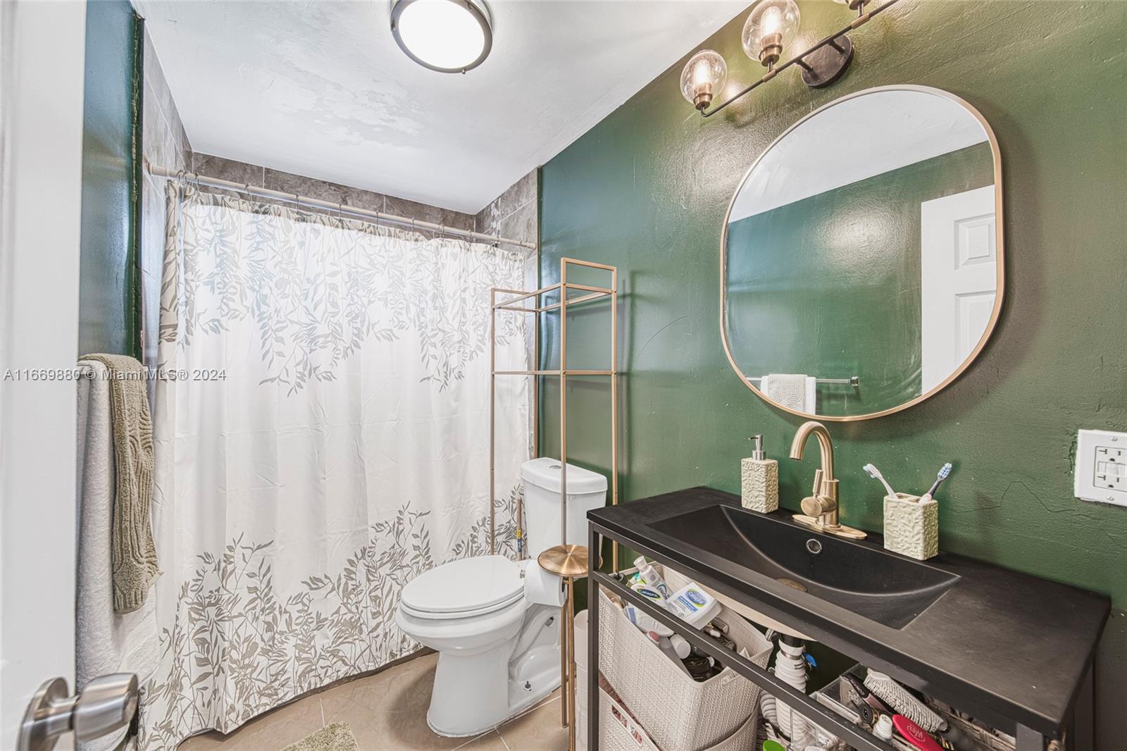 a bathroom with a granite countertop toilet sink and mirror