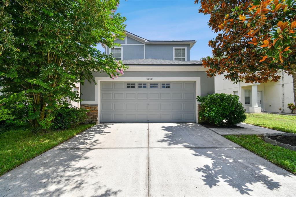 a front view of a house with a yard and garage