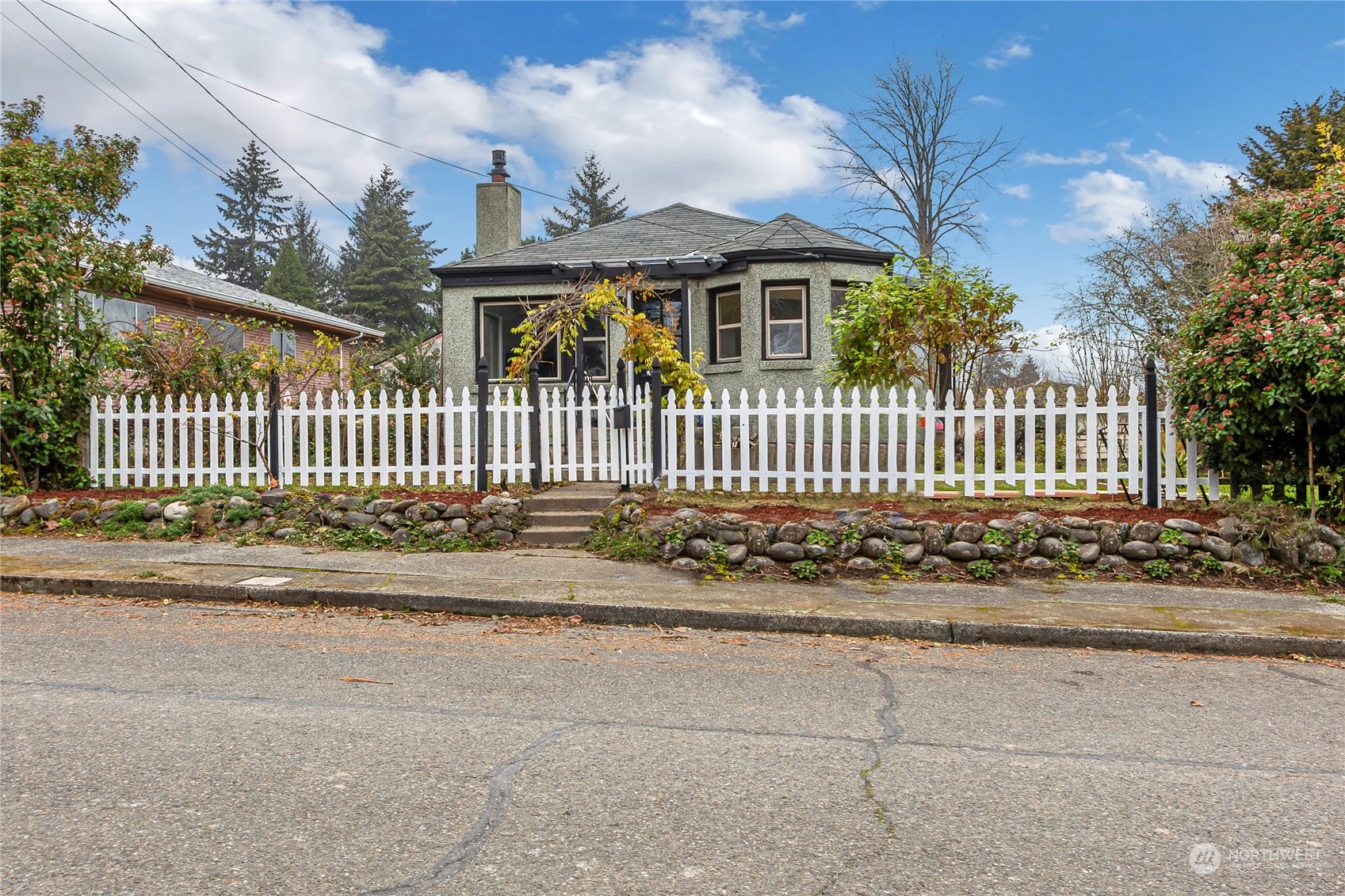 a front view of a house with a garden