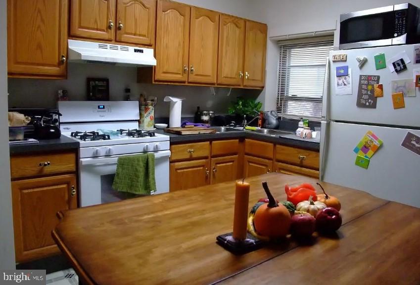 a kitchen with a sink a stove and cabinets