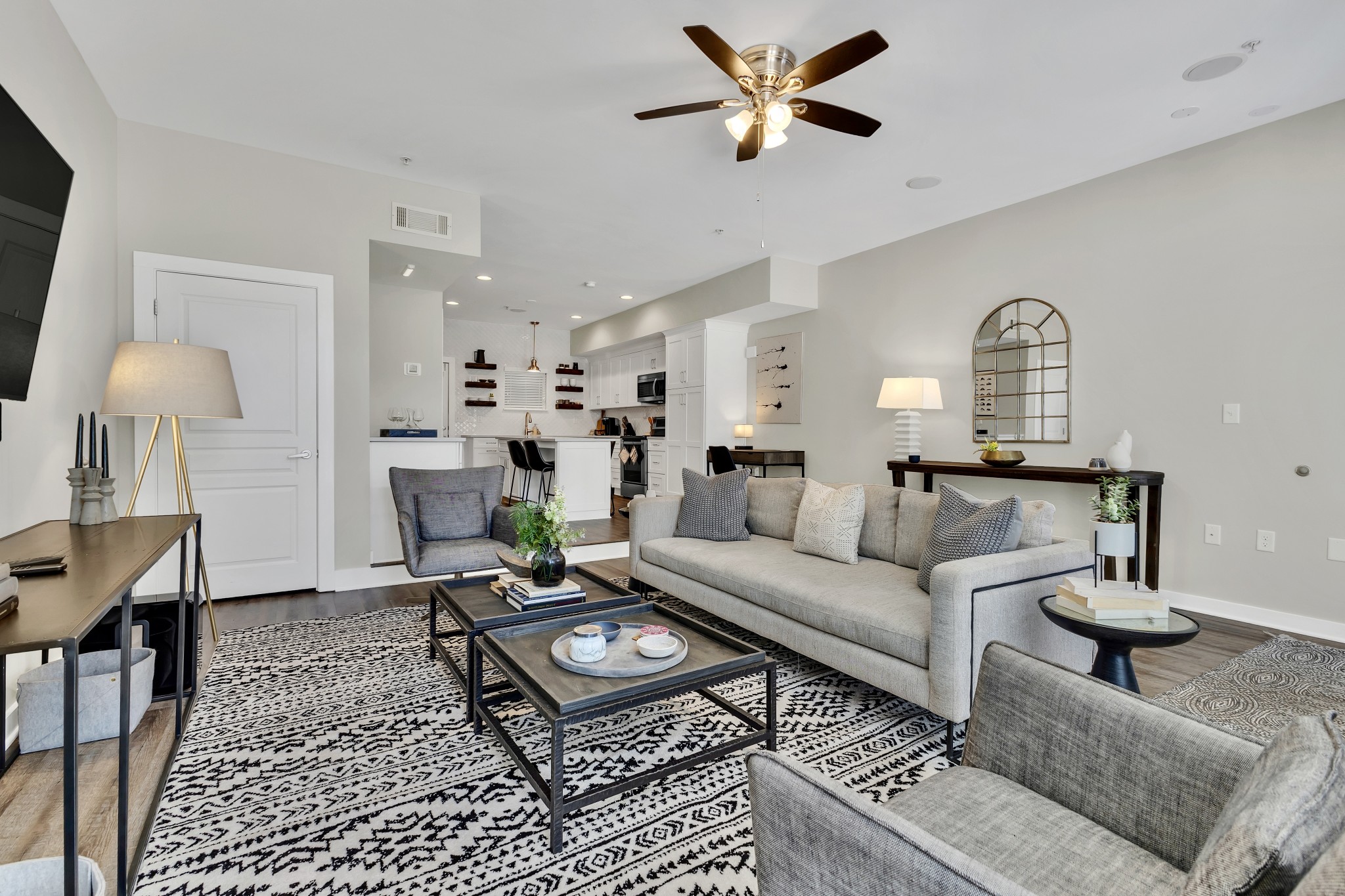 a living room with furniture a rug and a chandelier